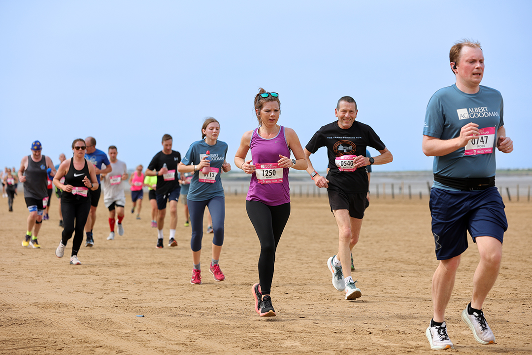 Runners race across the sand in the Weston Half Marathon